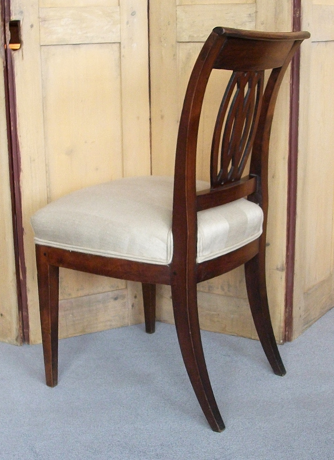  	Italian walnut chairs with sabre back legs and decorative pierced back splat. 